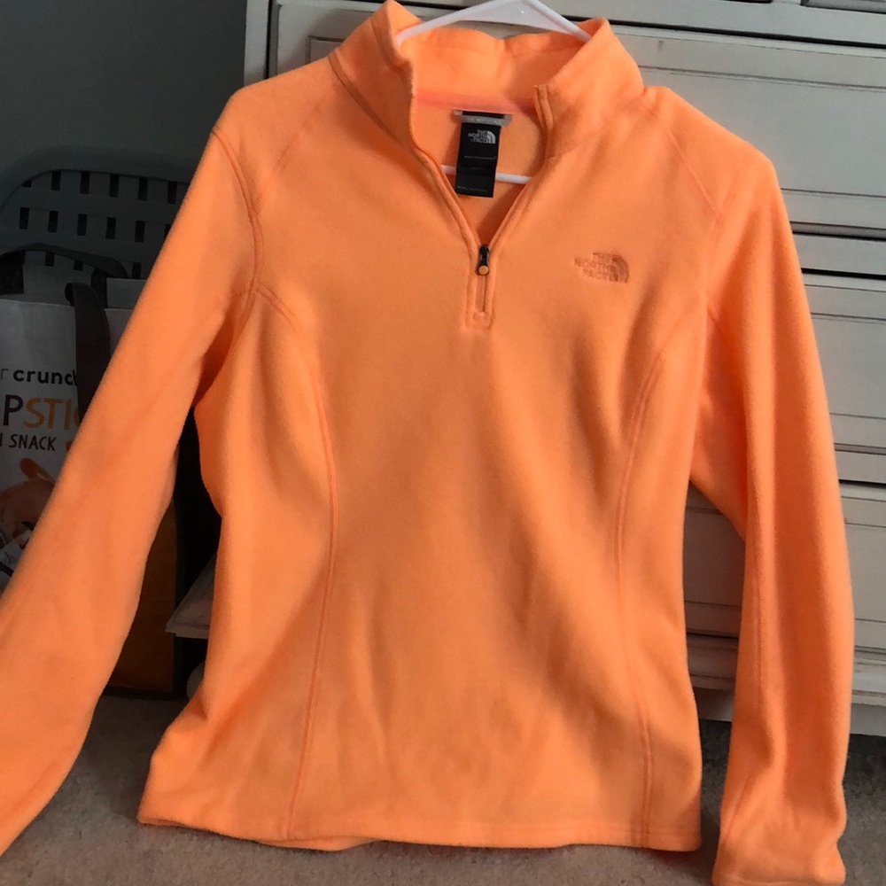 Bright orange north face fleece.